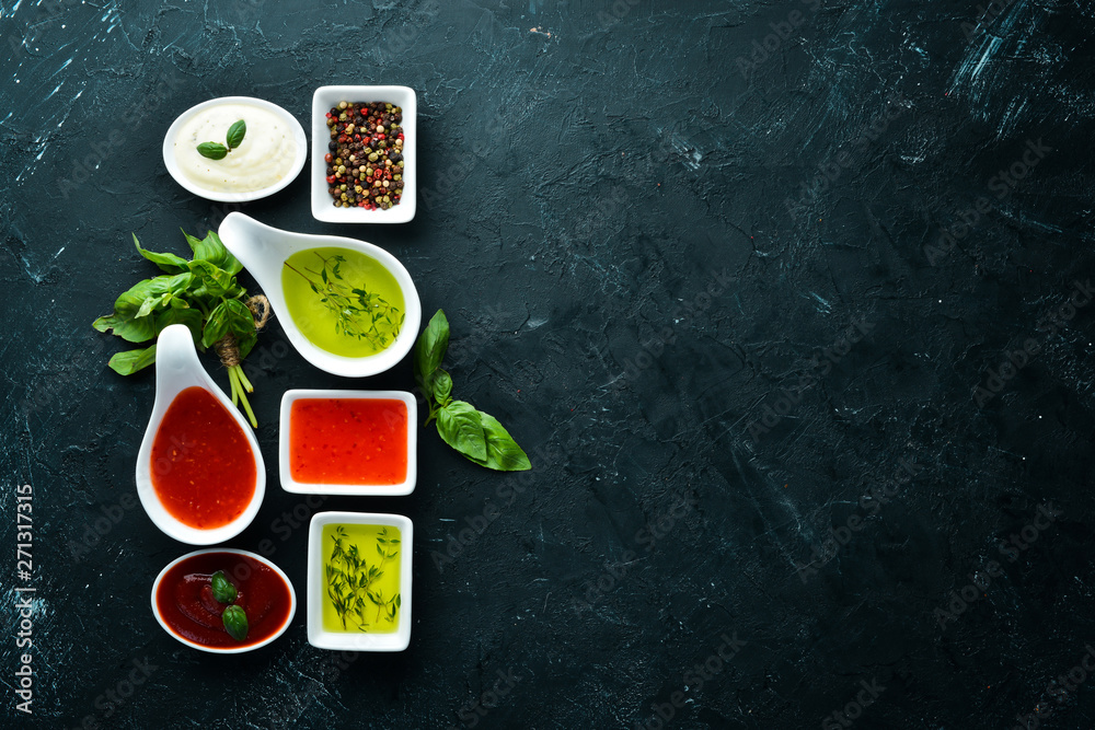 Set sauces and spices. On a wooden background. Top view. Free space for your text. Set sauces and spices. On a wooden background. Top view. Free space for your text.