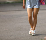 gait of female legs on heeled shoes