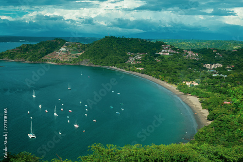 .Many boats and ships in the turquoise bay. Blue lagoon among trees aerial view. Seascape with boats and boats from above. Costa Rica beaches Playas del Coco. no people, no body