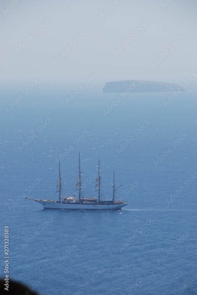 Ship sailing off the coast of Santorini Island