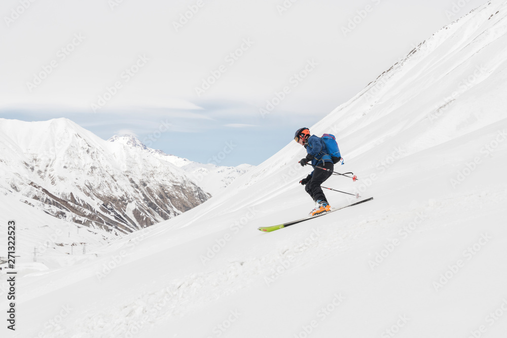 Georgia, Caucasus, Gudauri, man on a ski tour riding downhill Georgia, Caucasus, Gudauri, man on a ski tour riding downhill
