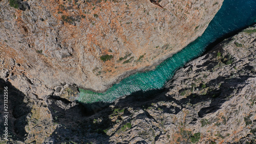 Aerial drone photo of heavenly turquoise rocky beach in shape of fjord of Seitan limania or Agiou Stefanou, Chania - Akrotiri, Crete, Greece