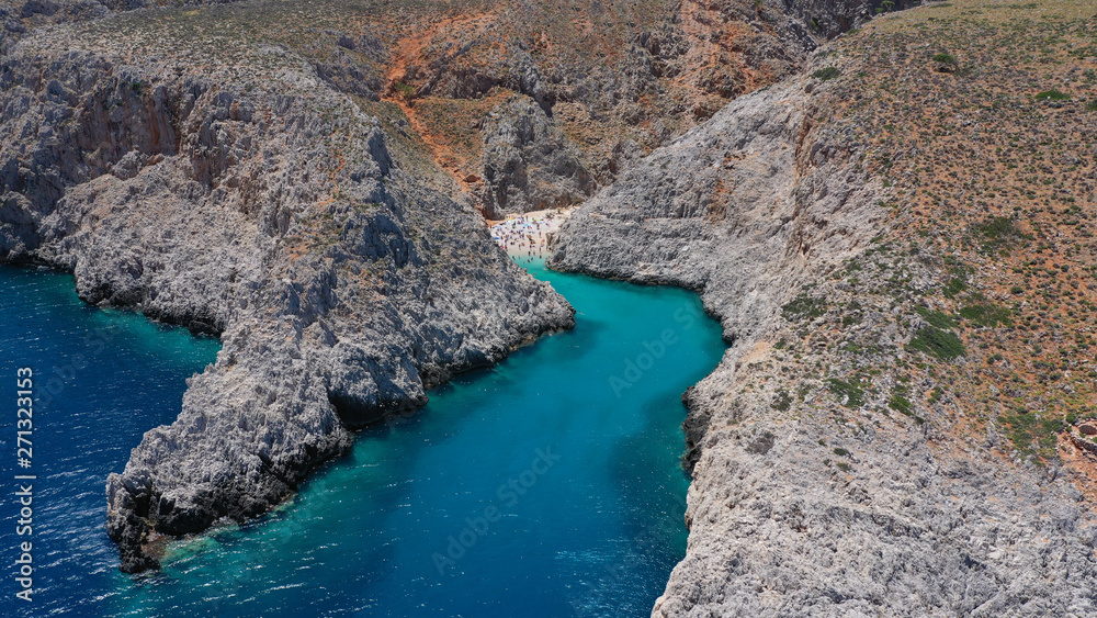 Obraz premium Aerial drone photo of heavenly turquoise rocky beach in shape of fjord of Seitan limania or Agiou Stefanou, Chania - Akrotiri, Crete, Greece