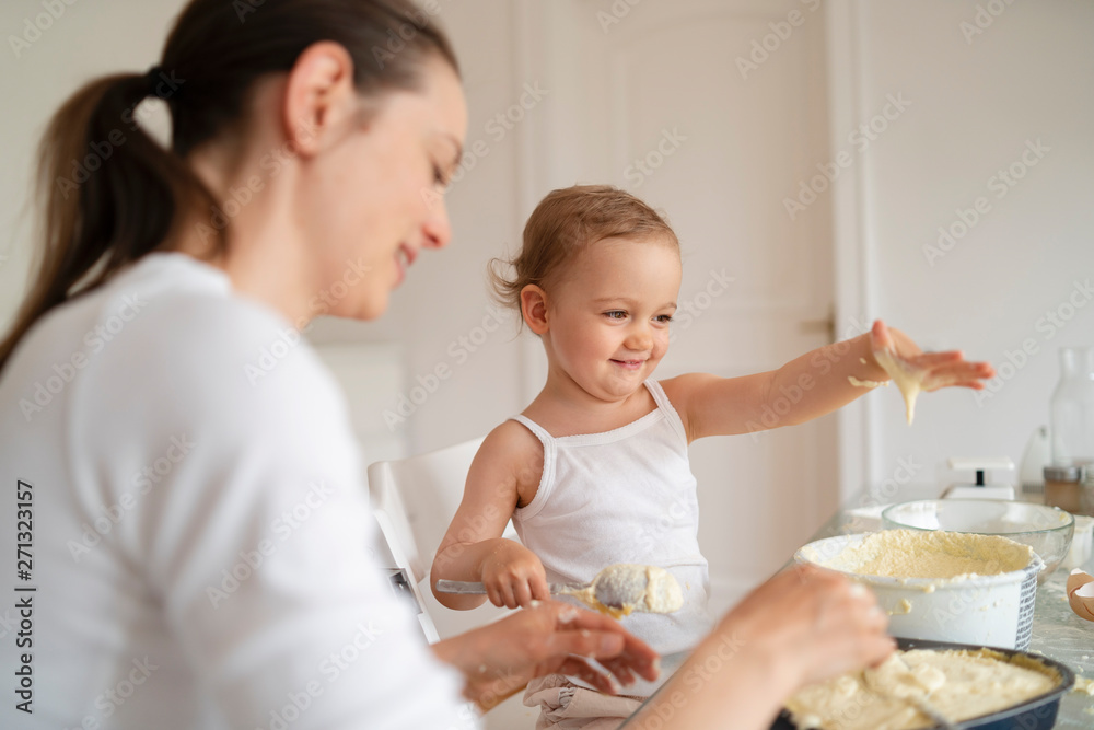 Mother and daughter making cake at home Mother and daughter making cake at home