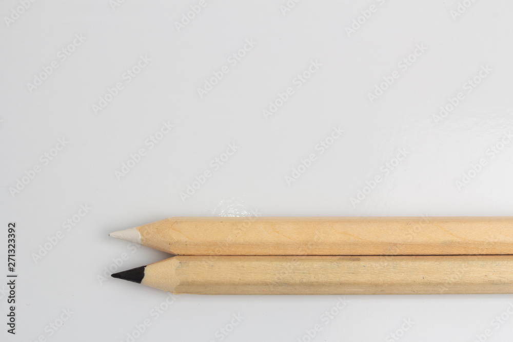 Obraz premium White and black pencils on white background
