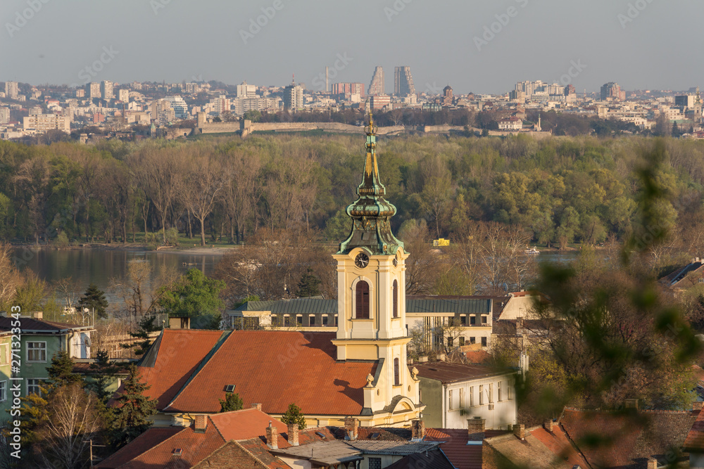 Beautiful view from Gardos in Zemun municipality over church in the foreground and Belgrade cityscape in the background. Golden hour.