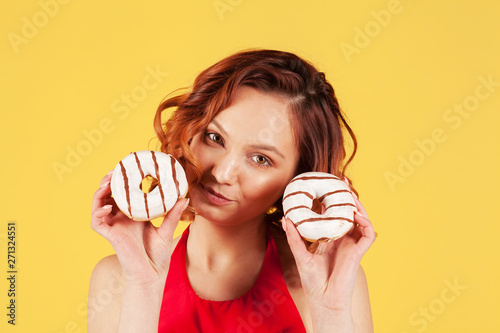 beautiful girl holding striped donuts with stripes