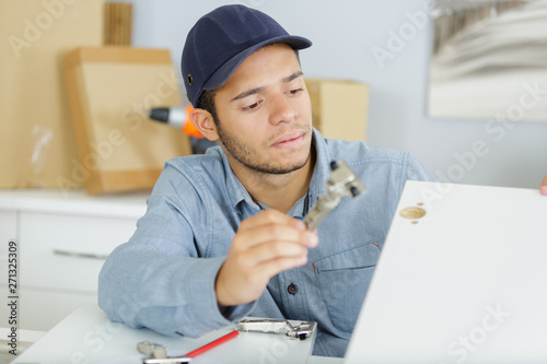 repair technician working with laptop