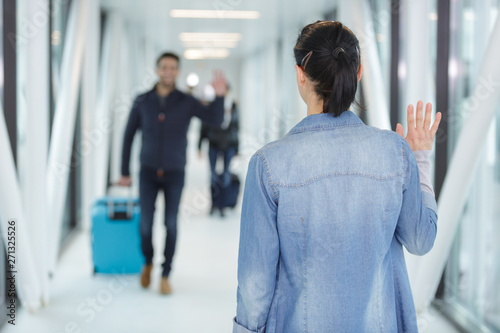 woman waiting for man in airport photo