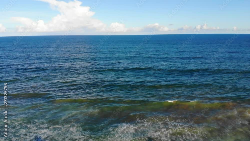 Aerial drone view flying over tropical ocean and blue waves. Brazilian beach at Villas do Atlântico, Bahia, Brazil. Aerial drone view flying over tropical ocean and blue waves. Brazilian beach at Villas do Atlântico, Bahia, Brazil.