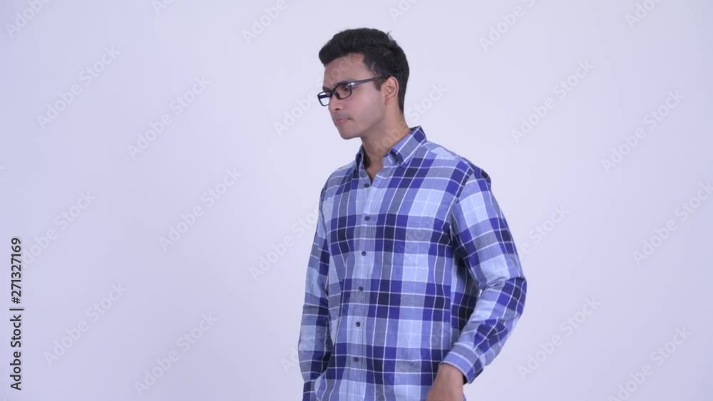 Stressed young Indian hipster man looking bored and tired