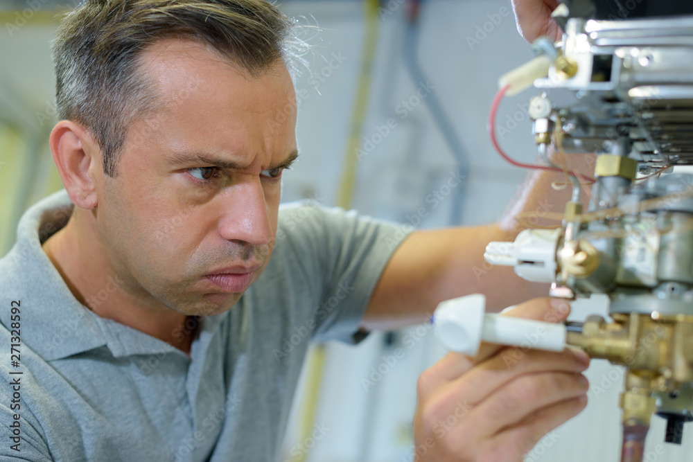 Fototapeta premium electrician fixing a machine