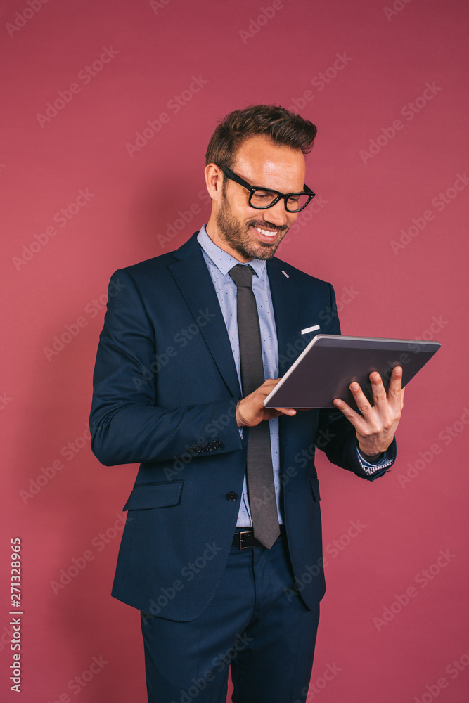 Handsome businessman working in a tablet Handsome businessman working in a tablet