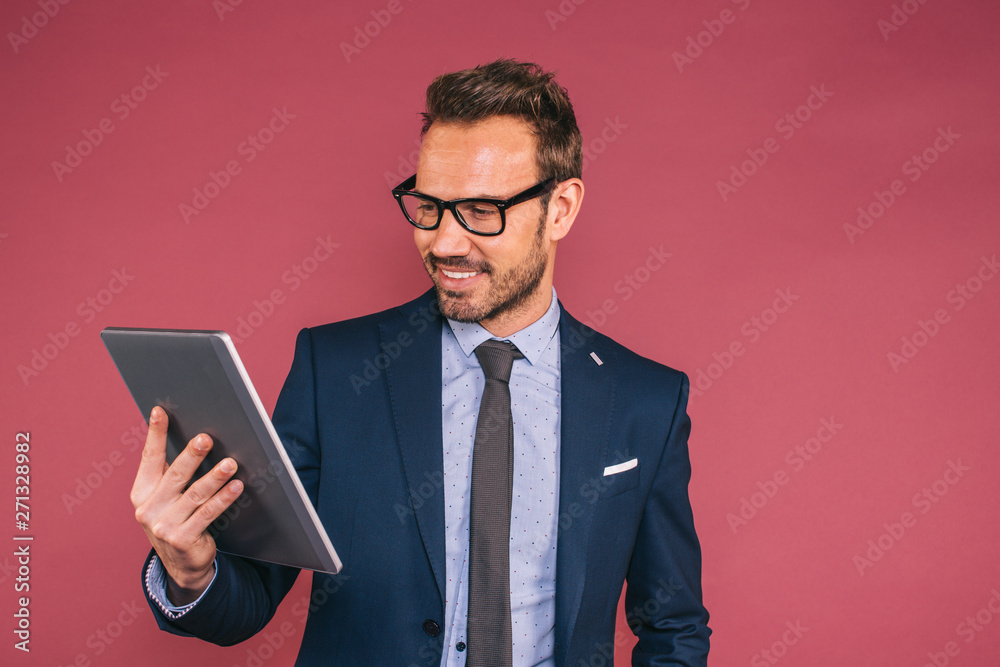 Handsome businessman working in a tablet Handsome businessman working in a tablet