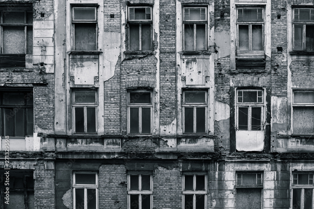 Black and white half-destroyed front of the building grungy and high-contrast Black and white half-destroyed front of the building grungy and high-contrast