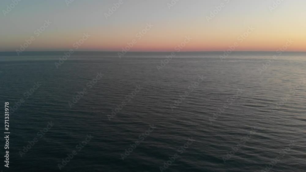 Camera flies over the blur ocean waves to the clean horizon. The camera flies forward over the sea into the sunset. Aerial view 4K Camera flies over the blur ocean waves to the clean horizon. The camera flies forward over the sea into the sunset. Aerial view 4K