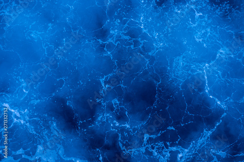 Dark blue deep sea surface, water with sea foam on a stormy day © Sergey Bogomyako