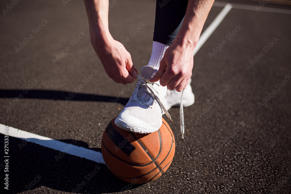 Basketball player tying basketball shoes Stock Photo Adobe Stock