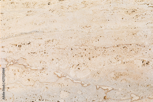 Closeup of beige porous stone textured wall. Neutral beige nature background for design and skins. photo