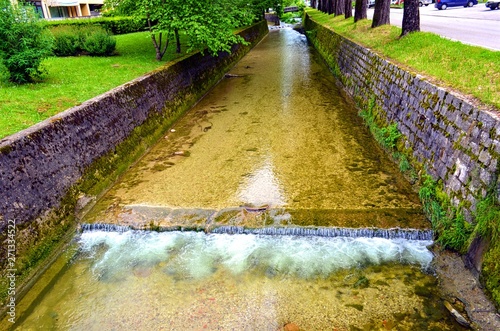 shallow channel with a threshold running between the road and the residential part in the city