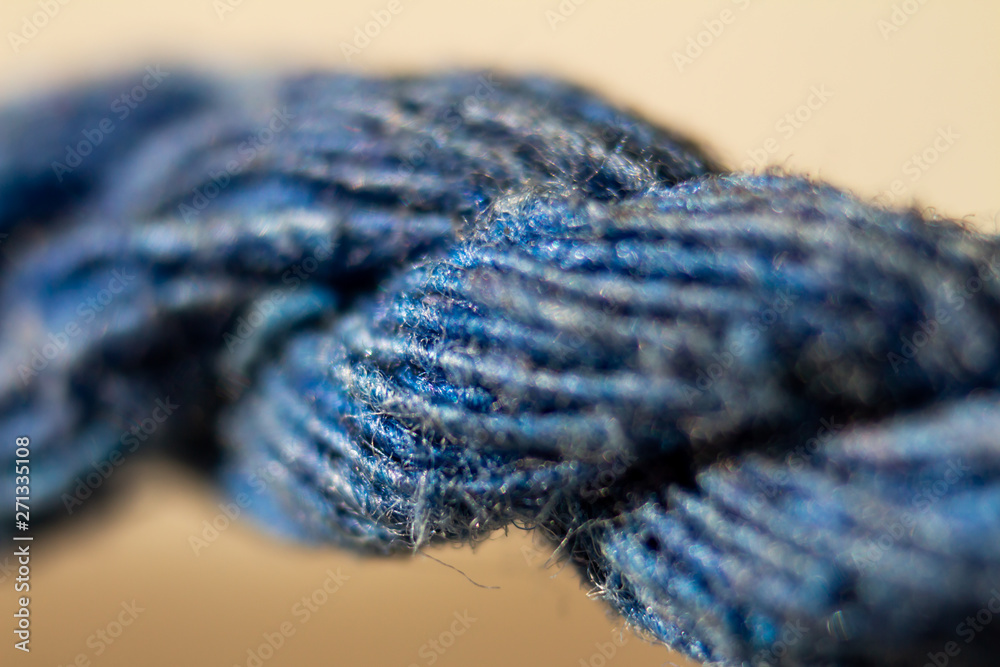 An Approaching a twisted rope of bluish colors.