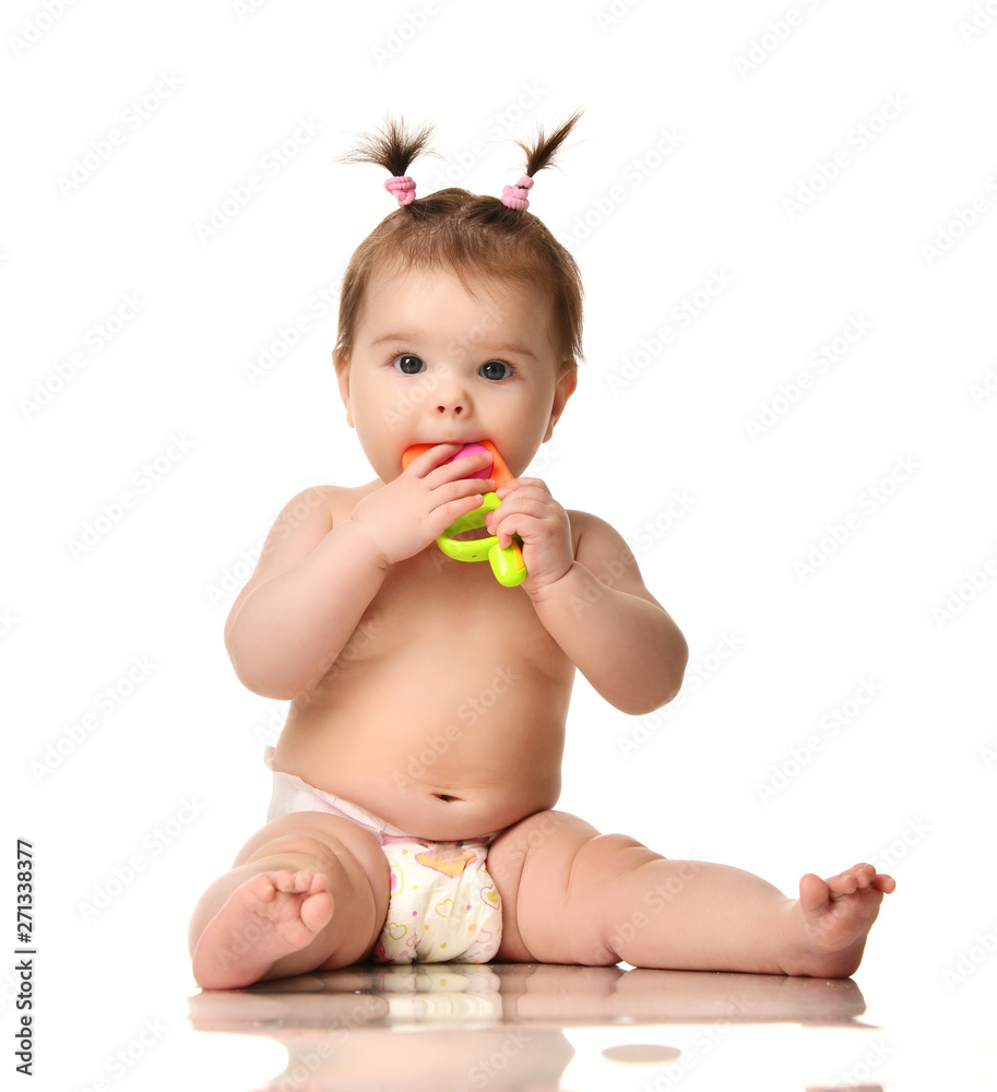 Infant child baby girl toddler sitting in diaper happy smiling laughing playing with plastic toy ice cream isolated Infant child baby girl toddler sitting in diaper happy smiling laughing playing with plastic toy ice cream isolated