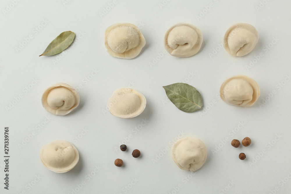 Composition with dumplings, bay leaves and pepper on white background, top view