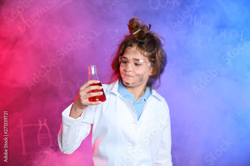 Emotional pupil holding conical flask in smoke against blackboard with chemistry formulas