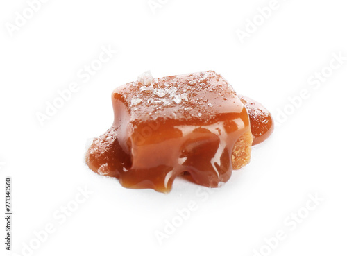 Delicious candy with caramel sauce and salt on white background