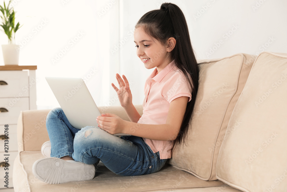 Little girl using video chat on laptop at home Little girl using video chat on laptop at home