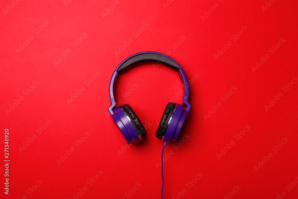 Stylish modern headphones on color background, top view Stylish modern headphones on color background, top view