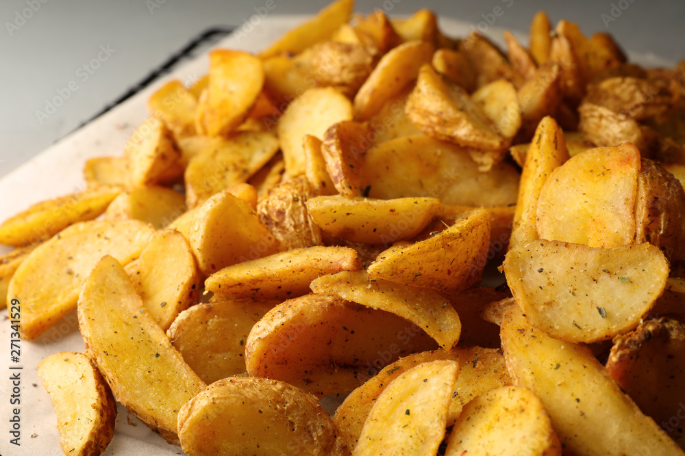 Delicious oven baked potatoes on parchment, closeup Delicious oven baked potatoes on parchment, closeup