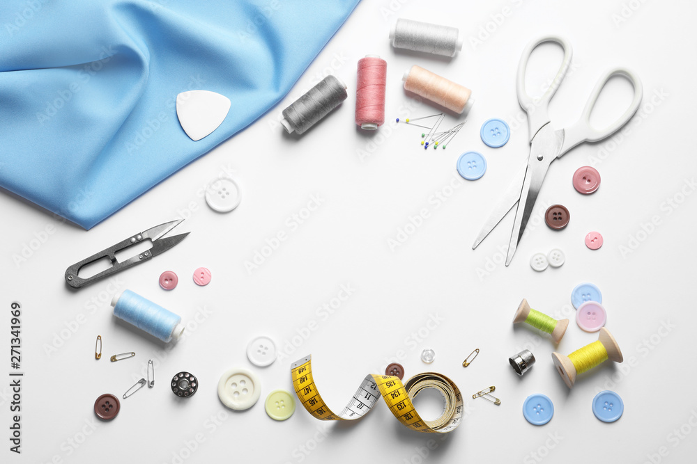 Flat lay composition with scissors and sewing supplies on white background. Space for text Flat lay composition with scissors and sewing supplies on white background. Space for text