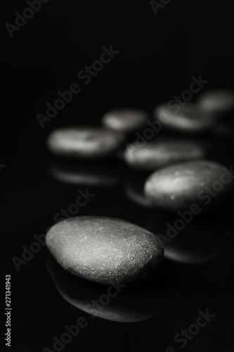 Spa stones on black background. Space for text
