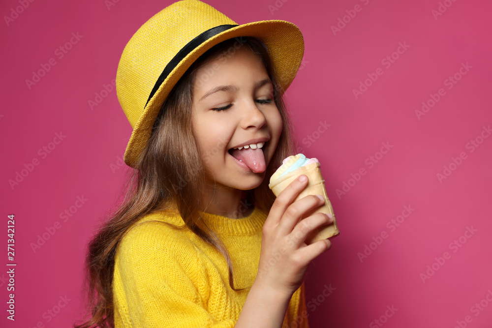 Adorable little girl with delicious ice cream against color background Adorable little girl with delicious ice cream against color background