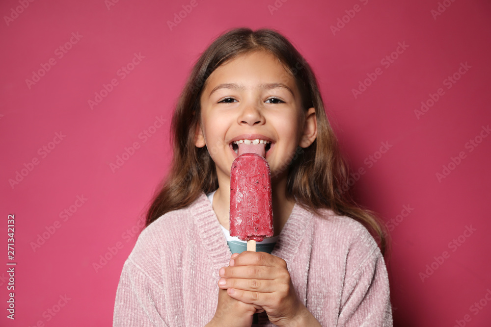 Adorable little girl with delicious ice cream against color background Adorable little girl with delicious ice cream against color background