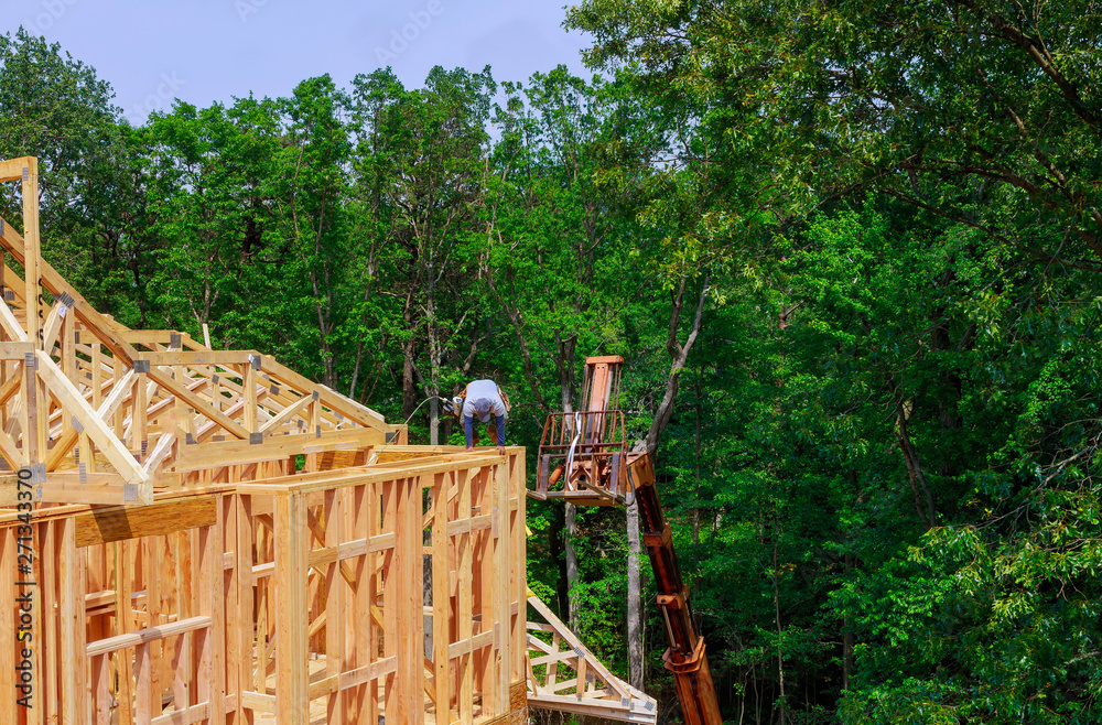 Looking up new construction beams under a clear blue sky with sunlight Looking up new construction beams under a clear blue sky with sunlight