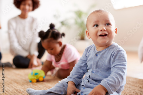 Two Mothers Meeting For Play Date With Babies At Home In Loft Apartment