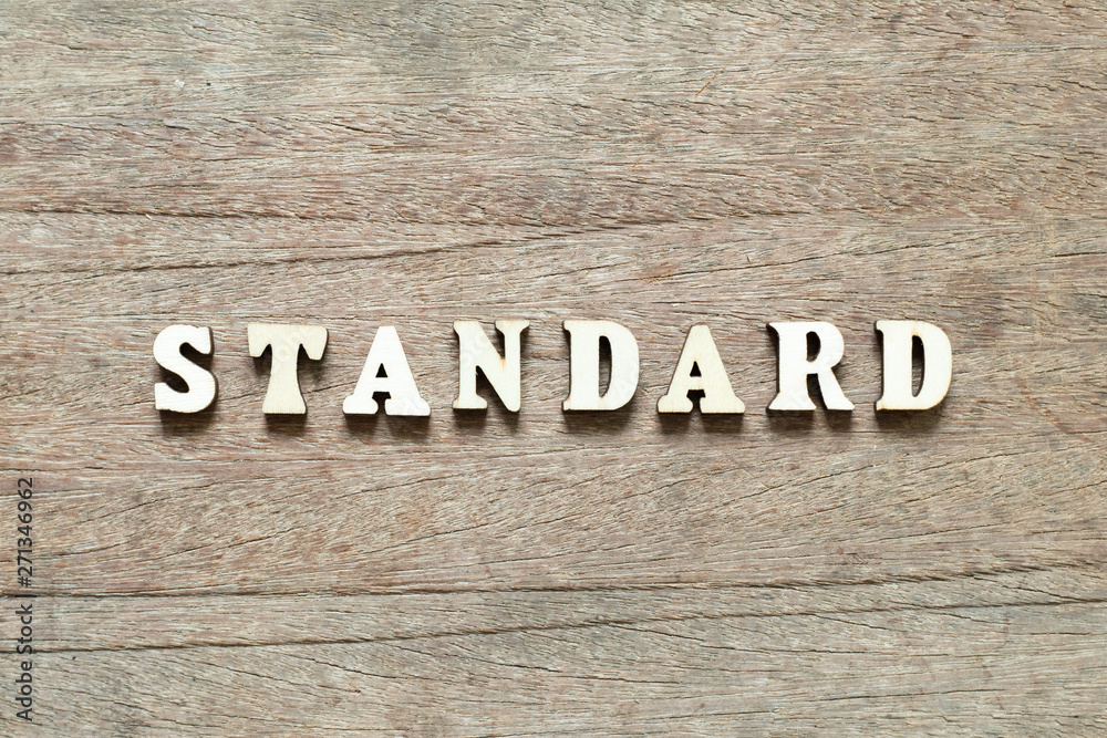 Letter block in word standard on wood background Letter block in word standard on wood background