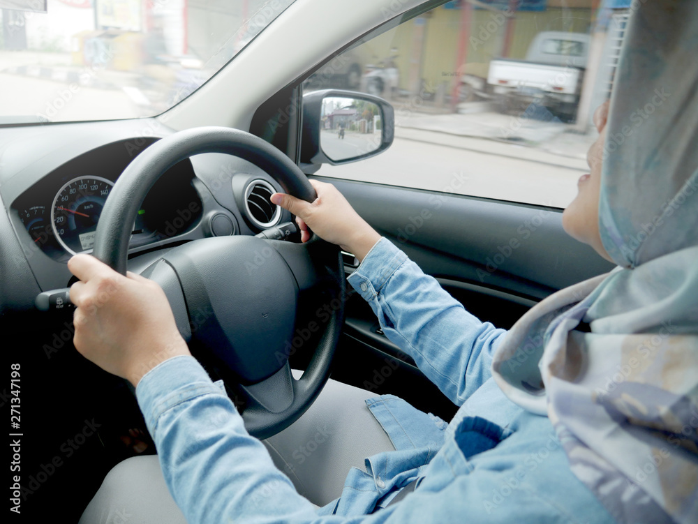 Smiling Muslim Lady Driving a Car
