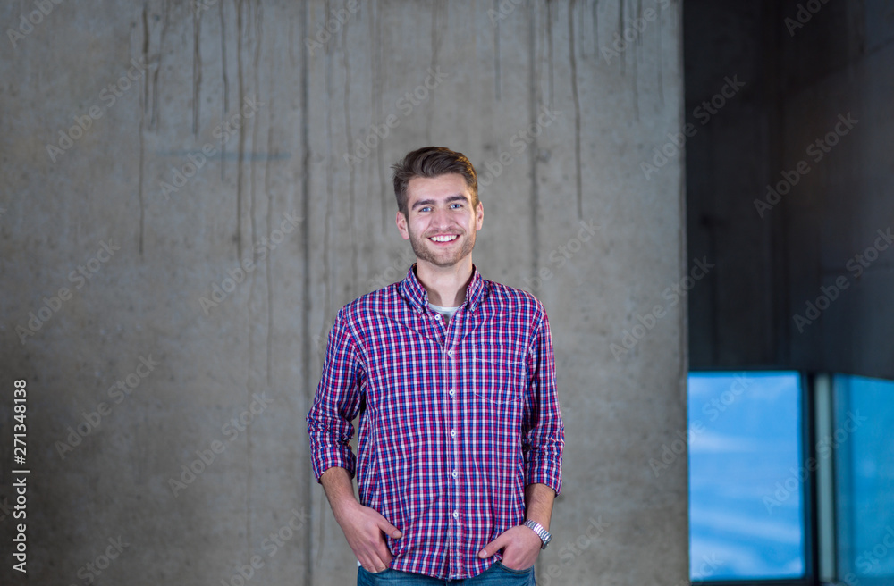 portrait of casual businessman in front of a concrete wall portrait of casual businessman in front of a concrete wall