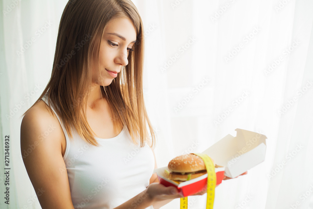 Diet. Young woman preventing her to eat junk food. Healthy eating concept
