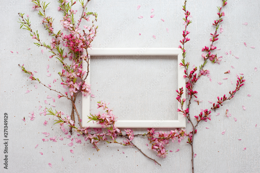 Flower composition with blooming pink branches with petals