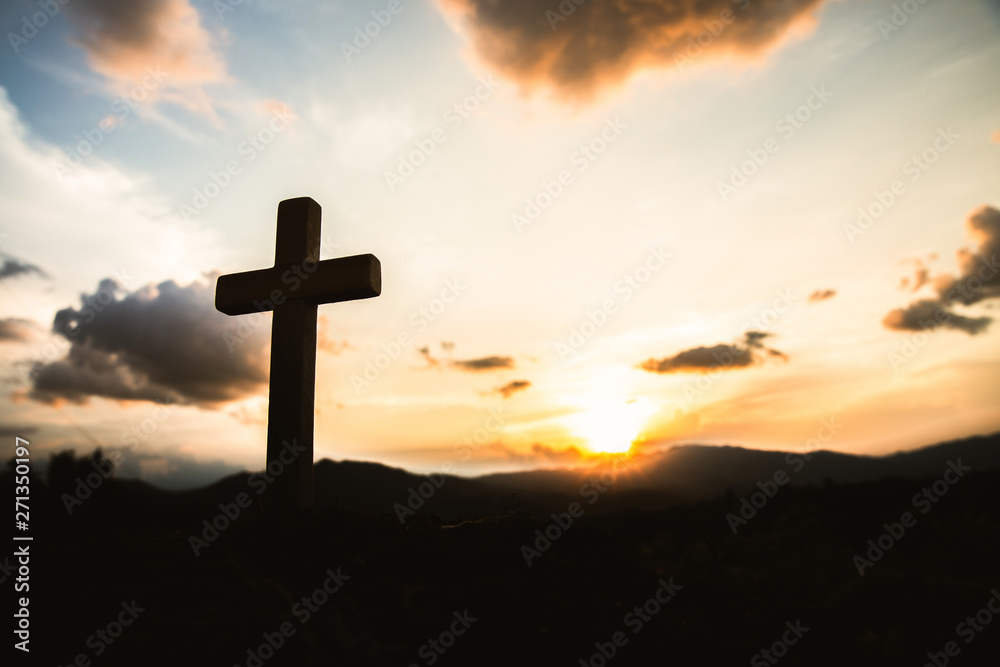 Religious concepts. Christian wooden cross on a background with dramatic lighting,  Jesus Christ cross, Easter, resurrection concept. Christianity, Religion copyspace background.