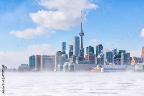 Toronto frozen lake Ontario. Early morning panoramic view of downtown with snow blizzard