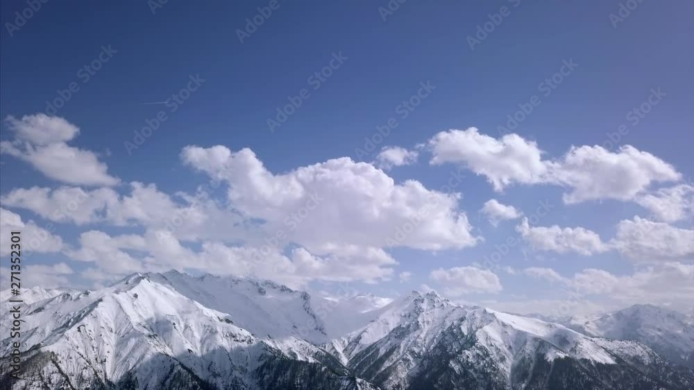 Aerial view of snowy mountain / Peak of the mountain and cloudy sky Aerial view of snowy mountain / Peak of the mountain and cloudy sky
