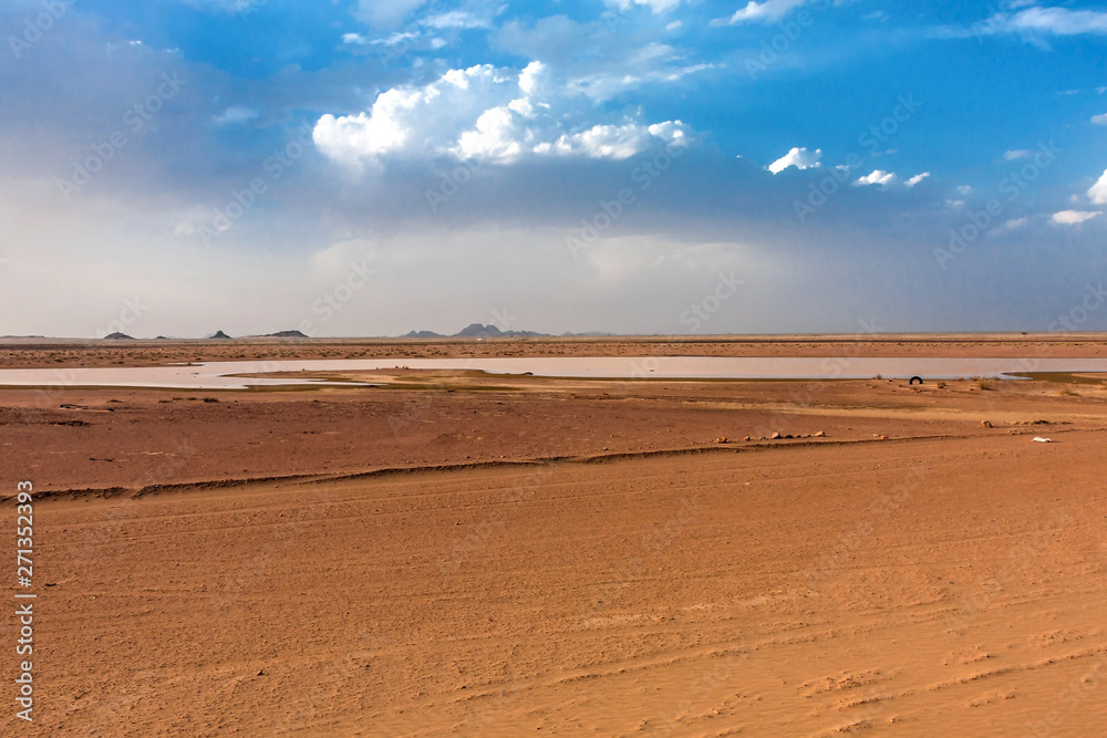 A desert landscape with a temporary pond after rain A desert landscape with a temporary pond after rain