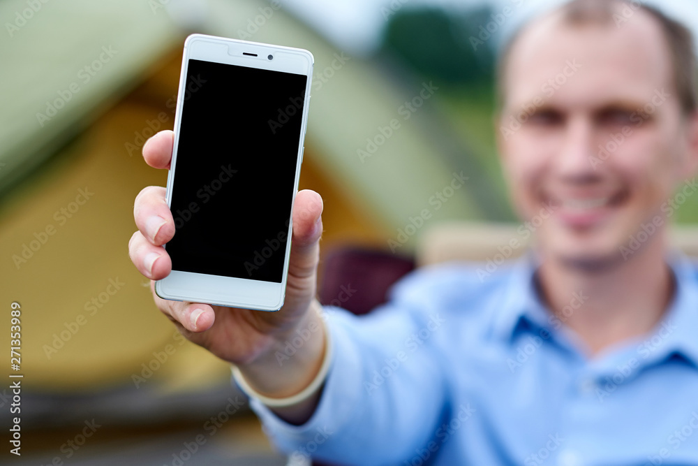 young man freelancer using smart phone. Black screen background place for text