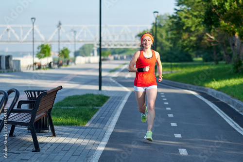 Running Woman on racetrack during training session. Female runner practicing on athletics race track © Joe-L