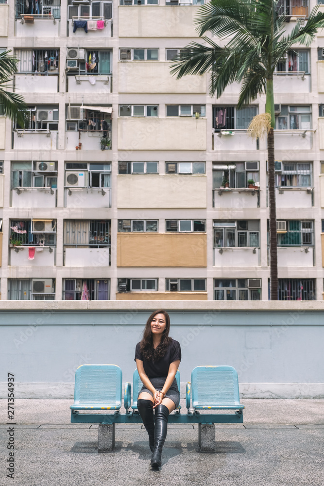 Portrait image of a beautiful asian woman with the vintage style pastel colors building in Hong Kong